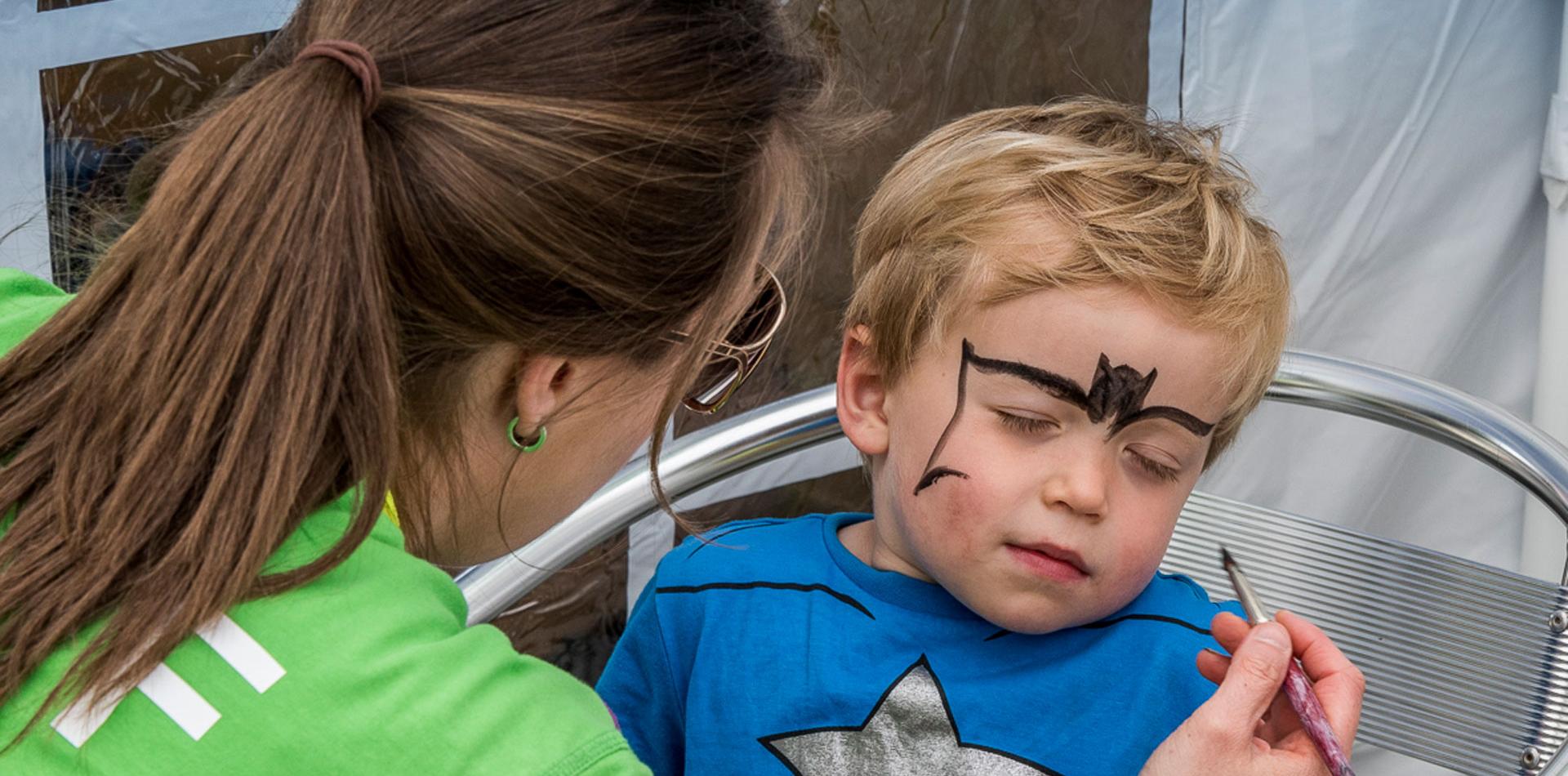 Child having his face painted